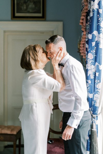 mother kissing groom