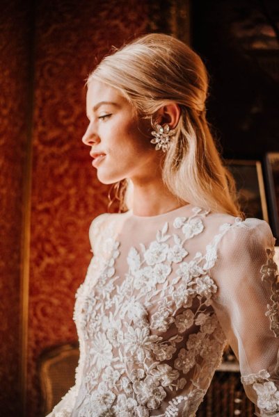 Close up of model wearing floral flower lace design from bridal gown dress collection