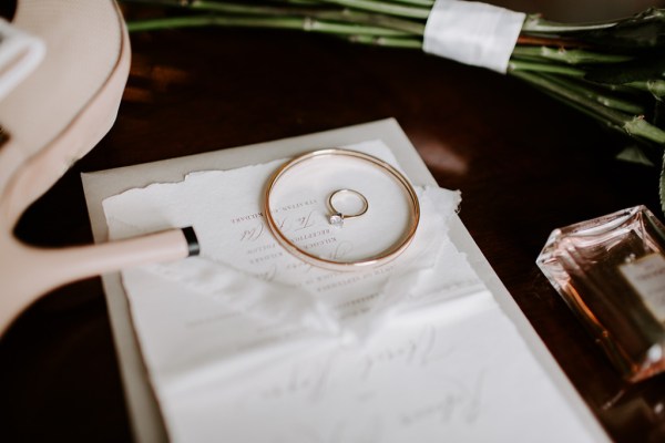 Up close wedding ring detail perfume table