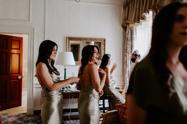 Laughing bridesmaid interior shot getting ready before ceremony