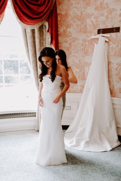 Interior shot of bride getting ready wedding dress bridesmaid veil