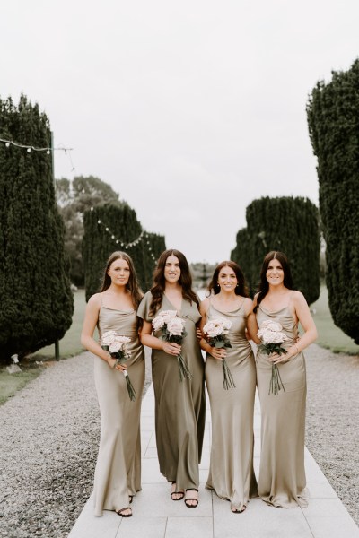 Bridesmaids exterior satin dresses bouquet of flowers