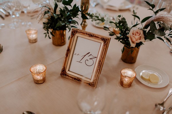 Up close close-up table number 13 flowers candle chocolate cutlery pink roses