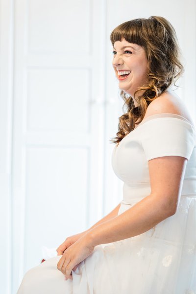 bride getting ready with bridesmaid