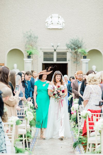 bride and mother walking up the aisle