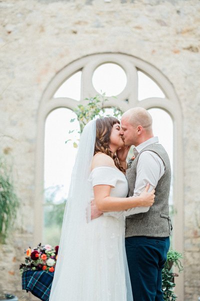 bride and groom top of altar tree planting ceremony kissing