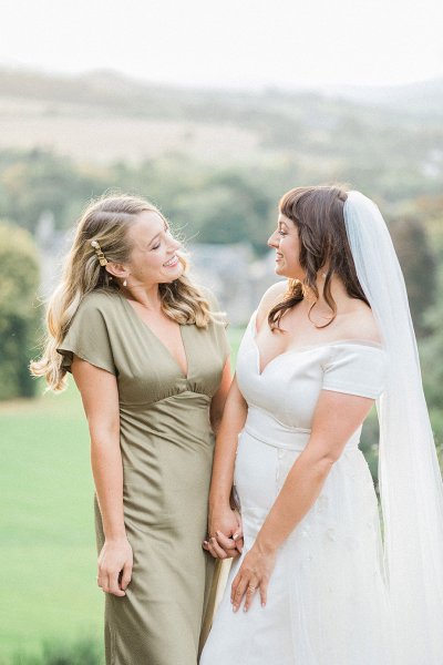 bride and bridesmaid smiling