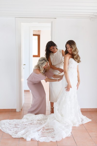 Bride train dress wavy hair getting ready bridesmaids