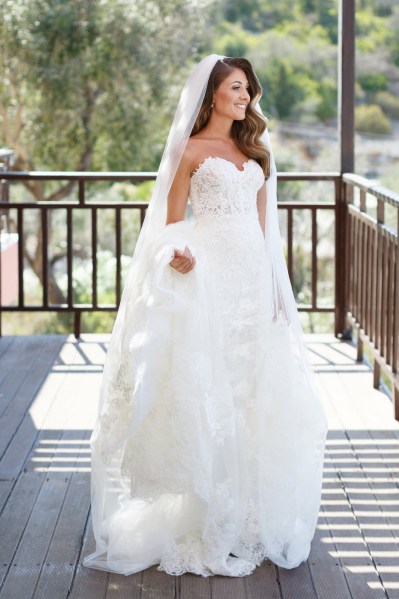 Bride veil train dress white exterior shot smiling sunshine