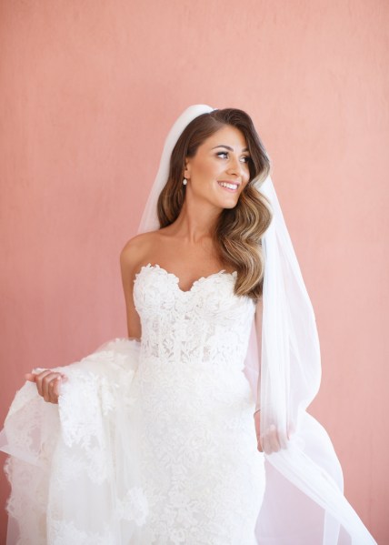 Bride veil train dress white interior shot smiling pink background