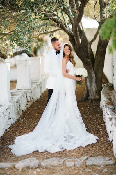 Interior bride and groom embrace ceremony bouquet of flowers exterior