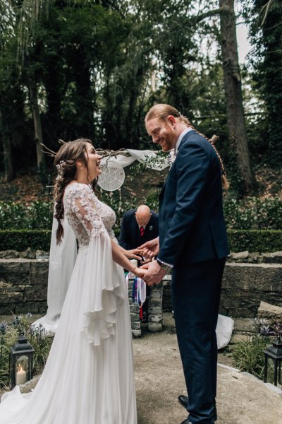 Bride and groom holding hands at wedding ceremony