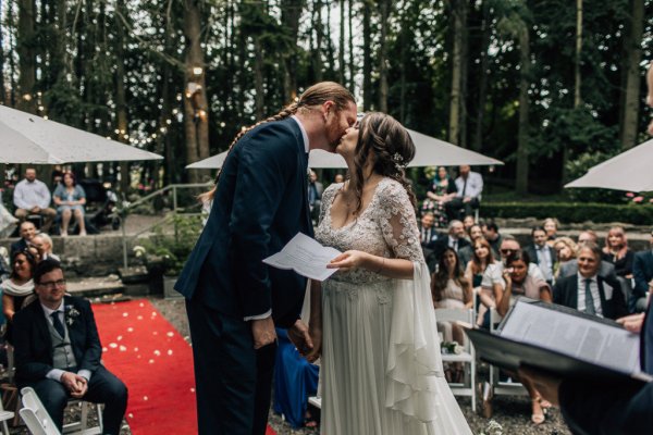 Bride and groom kiss on the cheek wedding ceremony