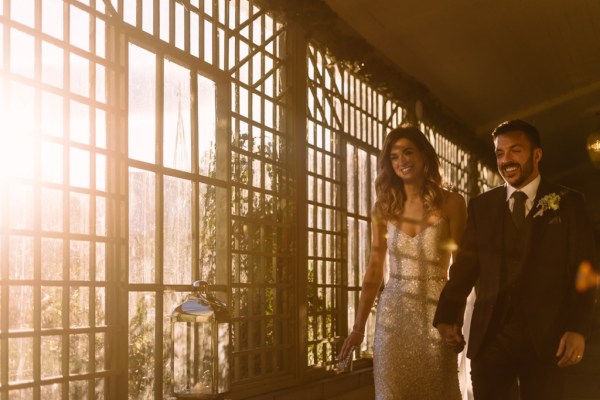 bride and groom walk in sunlight