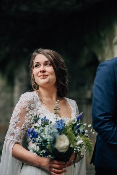 Bride exterior castle holding flowers bouquet