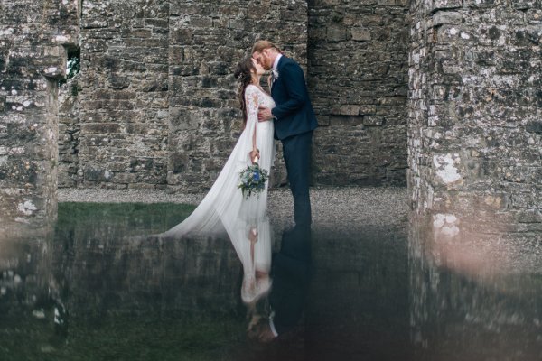 Bride and groom lake reflection water castle exterior