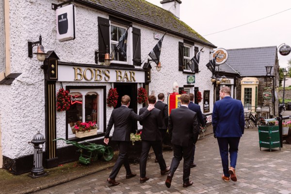 groomsmen outside pub maybe going for pint