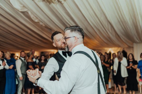 groom and groom mr and mr in tuxedos dancing