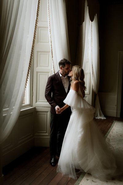 Bride and groom interior window curtains