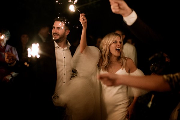 Bride cheers celebrating dancing with groom