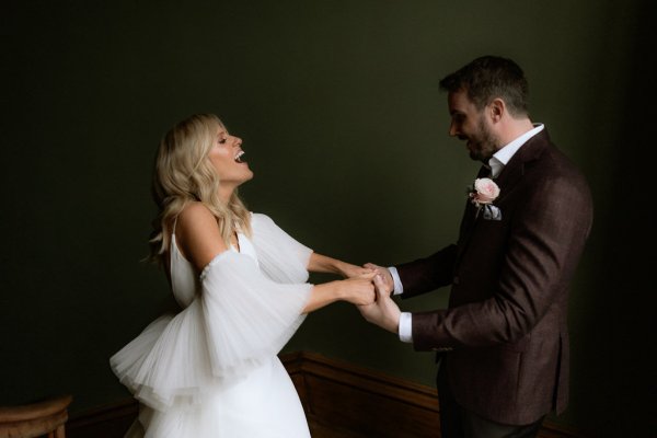 Bride and groom on stairs holding hands