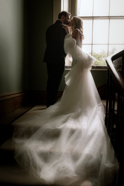 Train bridal gown flowy down stairs bride groom