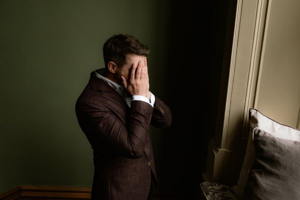 Groom covering face