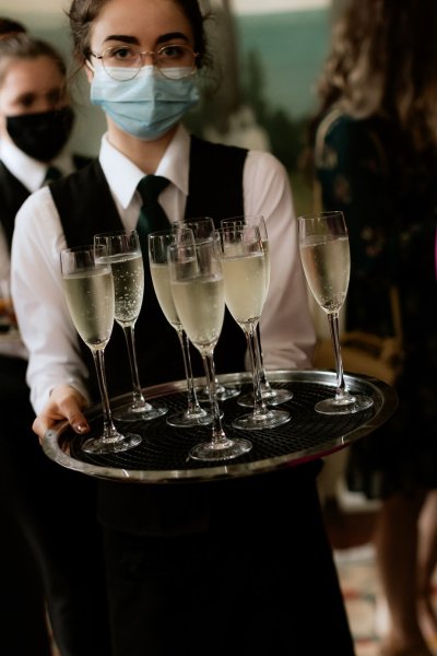 Waiter brings out glasses of champagne prosecco