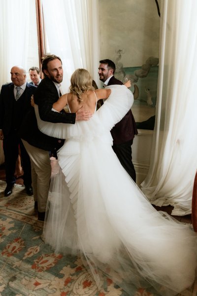 Bride long train cheers groom