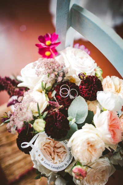 wedding rings or bands on pink flowers