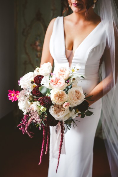 bridal bouquet with red pink flowers and horseshoe charm