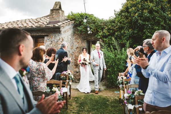 bride walks up the aisle with father