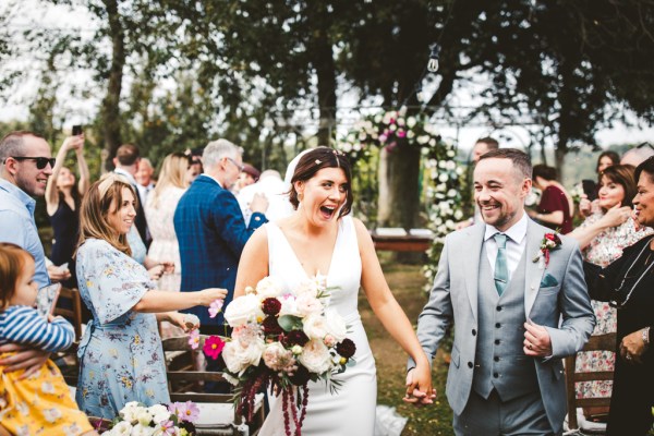 bride and groom couple showered with confetti