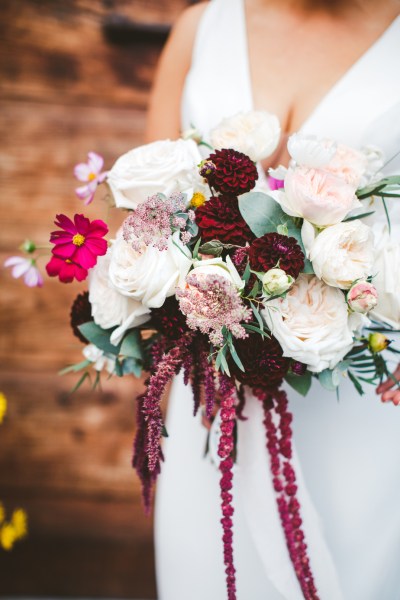 bridal bouquet with red pink flowers and horseshoe charm