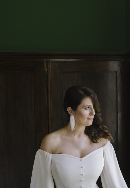 bride by window with earringss