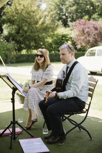 musicians play music and sing during drinks reception