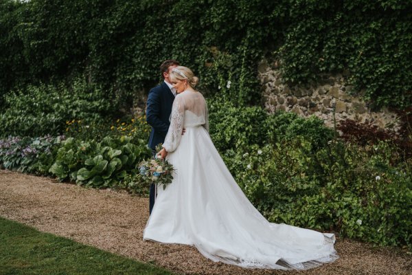 bride and groom wedding dress in gardens