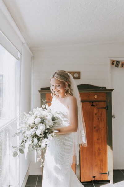 bride with white floral bouquet