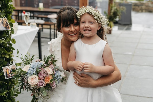 Bride little girl flowers bouquet photos exterior