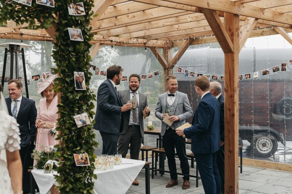 Groomsmen groom guests interior photos hanging ceremony cocktails