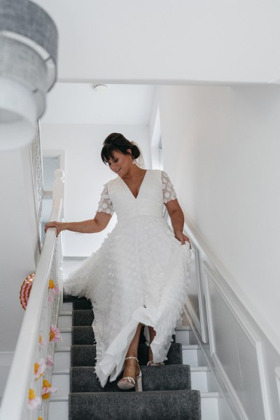 Bride walking down stairs getting ready