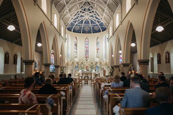 Interior wedding pew guests ceremony church