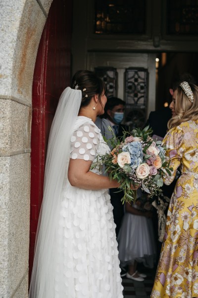 Bride holding bouquet of flowers after ceremony roses