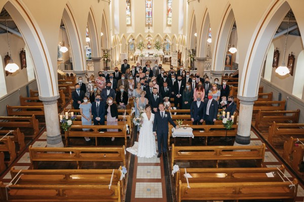 Guests family photo in church face masks ceremony celebration