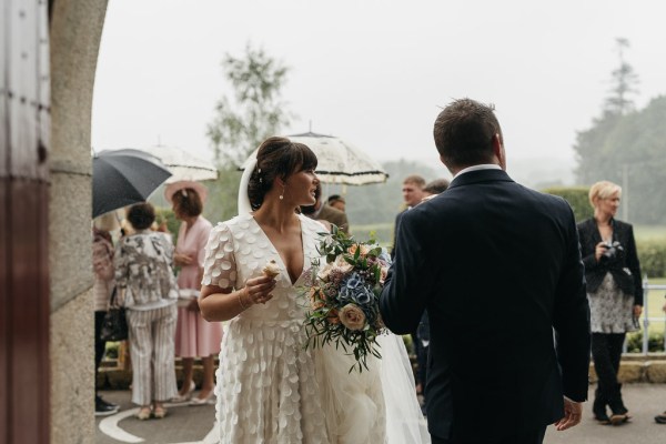 Exterior raining umbrella bride groom bouquet of flowers roses