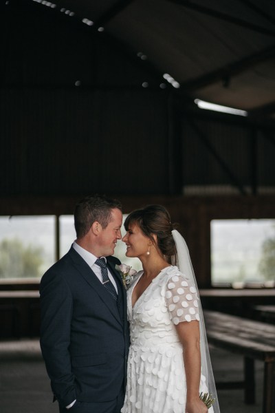 Bride and groom looking at each other touching nose