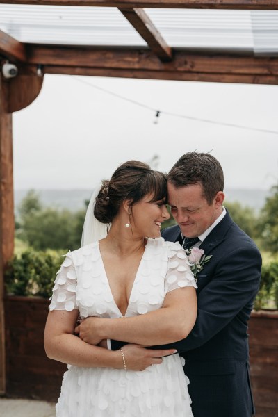 Groom holding bride hug embrace smiling. laughing exterior