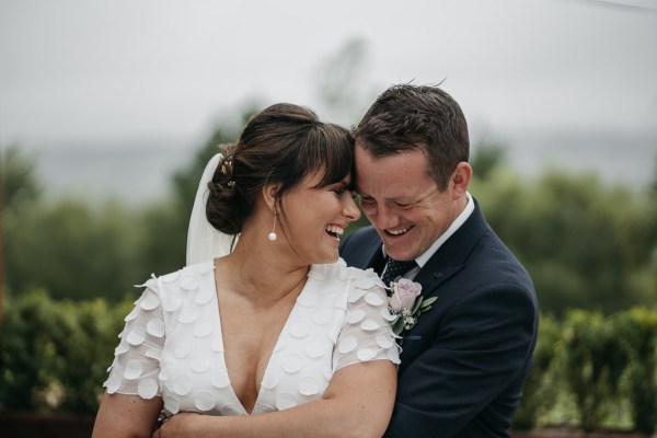 Groom holding bride hug embrace smiling. laughing exterior