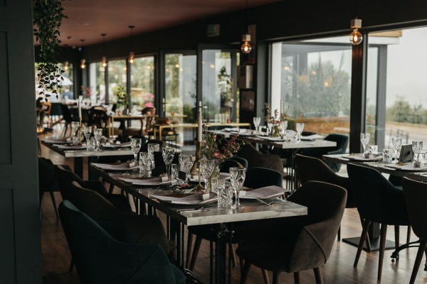 Interior moody setting dining room wine glasses evening shot lights