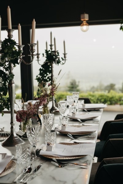 Interior moody setting dining room wine glasses evening shot lights